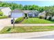 Charming single-story home with a well-manicured lawn, neatly trimmed bushes, and a two-car garage at 2627 Bridgeville Ln, Charlotte, NC 28262