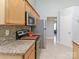 Kitchen with stainless steel appliances, mosaic backsplash and granite counter tops at 2627 Bridgeville Ln, Charlotte, NC 28262