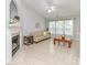 Inviting living room with a fireplace, neutral décor, tile flooring, and large windows for ample natural light at 2627 Bridgeville Ln, Charlotte, NC 28262