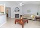 Cozy living room featuring an elegant fireplace, neutral tile flooring, and a comfortable seating arrangement at 2627 Bridgeville Ln, Charlotte, NC 28262