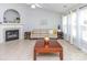Open-concept living room with a fireplace, neutral tile floors, and plenty of natural light from large windows at 2627 Bridgeville Ln, Charlotte, NC 28262