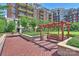 Tranquil courtyard featuring a pergola-shaded bench and landscaped grounds, with a building backdrop at 300 W 5Th St # 711, Charlotte, NC 28202