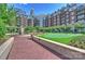 Serene courtyard featuring a putting green, fountain, and landscaped grounds in front of apartments at 300 W 5Th St # 711, Charlotte, NC 28202