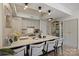 Bright open kitchen with island seating, sleek cabinets, and stainless steel appliances at 300 W 5Th St # 711, Charlotte, NC 28202