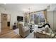 Living room showcasing modern furniture, large windows, and outdoor balcony at 300 W 5Th St # 711, Charlotte, NC 28202