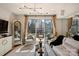 Stylish living room with balcony, contemporary decor, city view, and elegant grandfather clock at 300 W 5Th St # 711, Charlotte, NC 28202