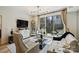 Living room showcasing modern furniture, large windows, and outdoor balcony at 300 W 5Th St # 711, Charlotte, NC 28202