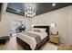 Modern bedroom featuring a stylish light fixture, grand piano in the connected room, and neutral tones at 300 W 5Th St # 711, Charlotte, NC 28202