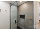 Modern shower features textured tile, glass door, and bronze fixtures at 300 W 5Th St # 711, Charlotte, NC 28202