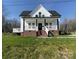 Charming two-story home with a welcoming front porch and brick foundation in a landscaped yard at 320 City Ave, Lancaster, SC 29720