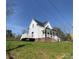 Bright white two-story house with covered porch and small side deck set on a grassy lot at 320 City Ave, Lancaster, SC 29720