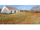 Backyard with grass with house having white vinyl siding and sliding glass doors at 324 Aniston Ln, Shelby, NC 28152