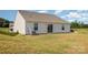 This property features a spacious yard with a sliding glass door leading into the home at 324 Aniston Ln, Shelby, NC 28152
