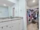 Bathroom with granite counters, ample lighting, vanity, and a view into the closet at 324 Aniston Ln, Shelby, NC 28152