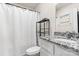 Bathroom featuring a white vanity with granite counter, toilet, and shower with curtain at 324 Aniston Ln, Shelby, NC 28152