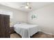 Cozy bedroom with ceiling fan, carpet, and a decorative turtle artwork on the wall at 324 Aniston Ln, Shelby, NC 28152