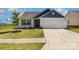 Charming single-story home featuring a two-car garage and well-manicured front lawn at 324 Aniston Ln, Shelby, NC 28152