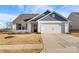 Charming single-story home with a two-car garage and well-maintained front lawn at 324 Aniston Ln, Shelby, NC 28152