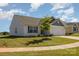 A charming single-story home featuring a well-kept lawn and a lovely young tree at 324 Aniston Ln, Shelby, NC 28152