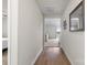 Bright hallway with hardwood floors leading to a living area and bedrooms at 324 Aniston Ln, Shelby, NC 28152