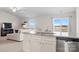 This kitchen features an island bar with seating and seamlessly opens to the living area at 324 Aniston Ln, Shelby, NC 28152