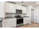 Kitchen featuring white cabinets, granite countertops and stainless steel appliances at 324 Aniston Ln, Shelby, NC 28152