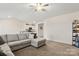 Open-concept living room featuring a large sectional sofa and adjacent kitchen at 324 Aniston Ln, Shelby, NC 28152