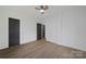 Bedroom showcasing wood-look floors, modern ceiling fan, and contrasting black doors and trim at 345 Grice St, Shelby, NC 28150