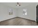 Bedroom with two windows providing natural light and highlighting the wood-look floors and contrasting black trim at 345 Grice St, Shelby, NC 28150