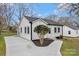 Cozy bungalow with a freshly paved driveway, white siding, and a well-kept yard at 345 Grice St, Shelby, NC 28150