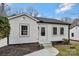 Charming bungalow with freshly painted white siding, black trim, and a neatly landscaped front yard at 345 Grice St, Shelby, NC 28150