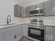 Beautifully updated kitchen featuring gray cabinets, stainless appliances, and new quartz counters at 345 Grice St, Shelby, NC 28150