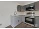 New kitchen with gray cabinets, stainless steel appliances, quartz countertop, and updated fixtures at 345 Grice St, Shelby, NC 28150
