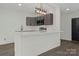 Modern kitchen features sleek gray cabinets, a stylish light fixture, and a spacious white breakfast bar at 345 Grice St, Shelby, NC 28150