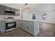 A spacious kitchen with gray cabinets, stainless steel appliances, and ample countertop space at 345 Grice St, Shelby, NC 28150