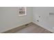 Functional laundry room featuring a window, wood-look flooring, and modern connections for appliances at 345 Grice St, Shelby, NC 28150