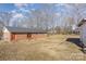 Backyard featuring a brick home with a large grassy area and a storage shed at 437 Valley St, Stanley, NC 28164