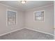 Comfortable bedroom featuring carpet, paneled walls and two windows at 437 Valley St, Stanley, NC 28164