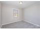 Cozy bedroom featuring carpet, paneled walls and a window at 437 Valley St, Stanley, NC 28164