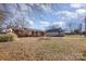 Traditional brick home with a welcoming front porch and well-maintained landscaping at 437 Valley St, Stanley, NC 28164