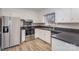Bright kitchen with stainless steel appliances, vinyl flooring, white cabinets, and dark countertops at 437 Valley St, Stanley, NC 28164