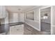 Galley style kitchen with white cabinets, dark counters and new vinyl flooring at 437 Valley St, Stanley, NC 28164