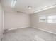 Spacious carpeted room with bright lighting, paneled walls and a large window at 437 Valley St, Stanley, NC 28164