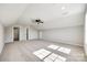 Large bonus room with neutral walls, plush carpet, and a modern ceiling fan for added comfort at 453 Cedar Grove Rd, Clover, SC 29710