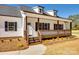 Inviting front porch with wood railing and posts on a charming white home at 453 Cedar Grove Rd, Clover, SC 29710