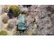 An aerial view of the green-roofed home surrounded by lush trees and foliage at 5124 Gates Dr, Denver, NC 28037
