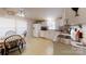 Bright kitchen with white cabinets, tile countertops, and a cozy dining area at 5124 Gates Dr, Denver, NC 28037