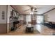 Inviting living room featuring a stone fireplace, ceiling fan, and wood-look floors at 5124 Gates Dr, Denver, NC 28037