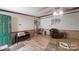 An open living area with wood-look flooring, a ceiling fan, and a comfortable seating area at 5124 Gates Dr, Denver, NC 28037