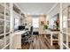 Home office with custom built-in shelving, hardwood floors, and a desk with dual monitors at 5316 Baker Ln, Clover, SC 29710